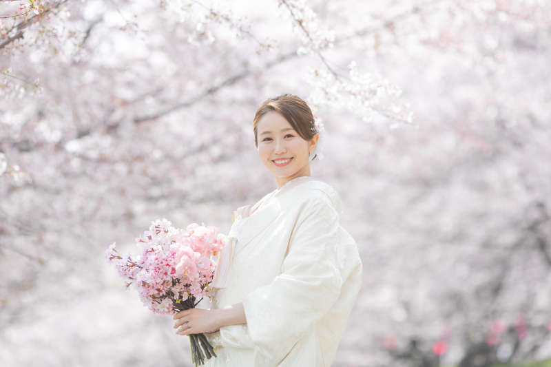 満開の桜並木とご新婦様の笑顔を印象的に残したお写真。桜、リップ、ブーケのピンク。白無垢の白。それぞれ似ていますが違う色を繊細に残しつつ、ご新婦様を引き立てるMISAKIならではの視点だと感じます。