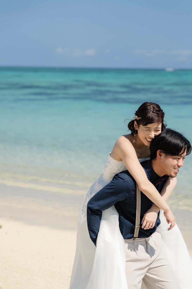 capryでは大人気のビーチでのおんぶショット。おふたりの良き関係性が伺えるゆるんだ表情に、ほっこりする気持ちに。あたたかくて柔らかい、おふたりらしいけれど、ちょっぴりトクベツな空間が出来上がります。