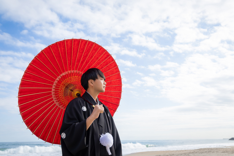 赤い和傘を手に、凛とした横顔を