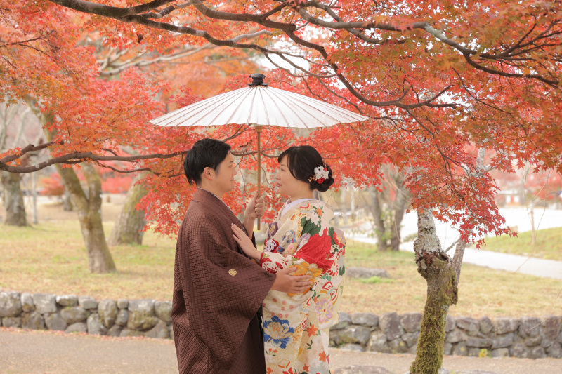 傘の下で向かい合うお二人