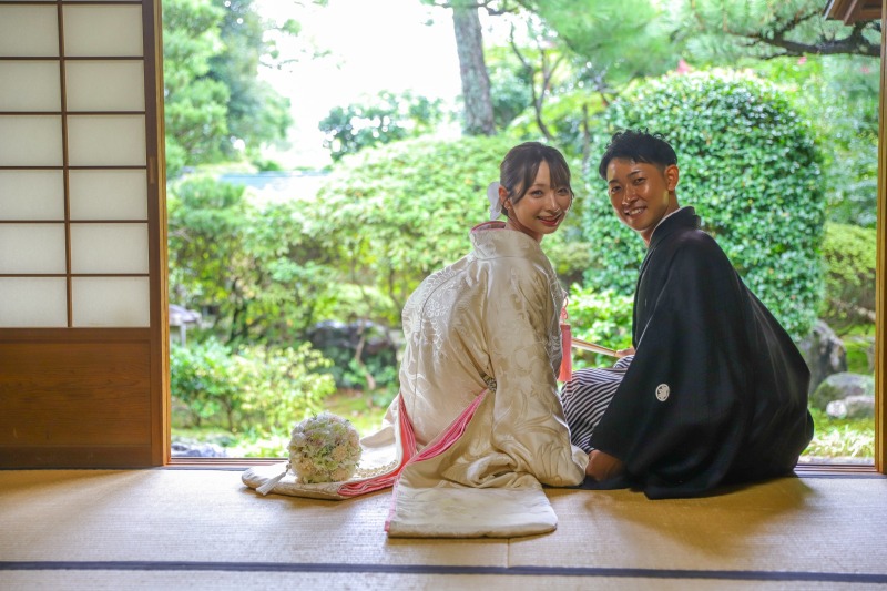 縁側から新緑の庭を望む二人の後ろ姿