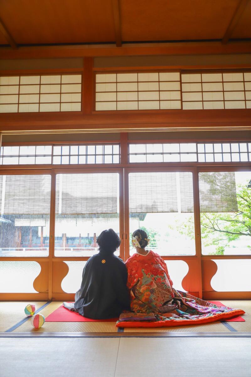 色打掛姿で縁側に寄り添う二人
