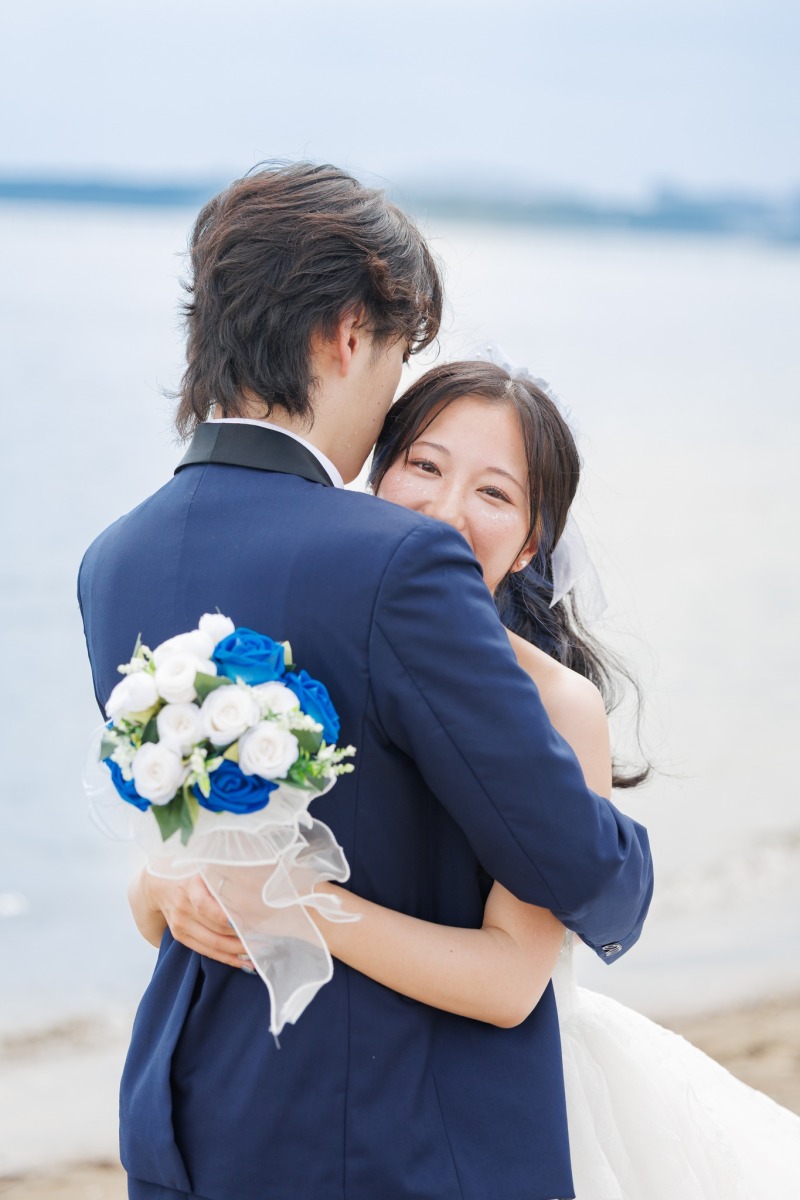 振り返る笑顔と青いブーケ