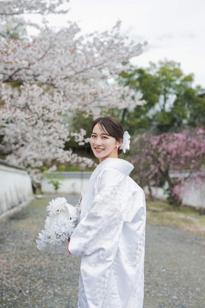 桜をバックに微笑む新婦様