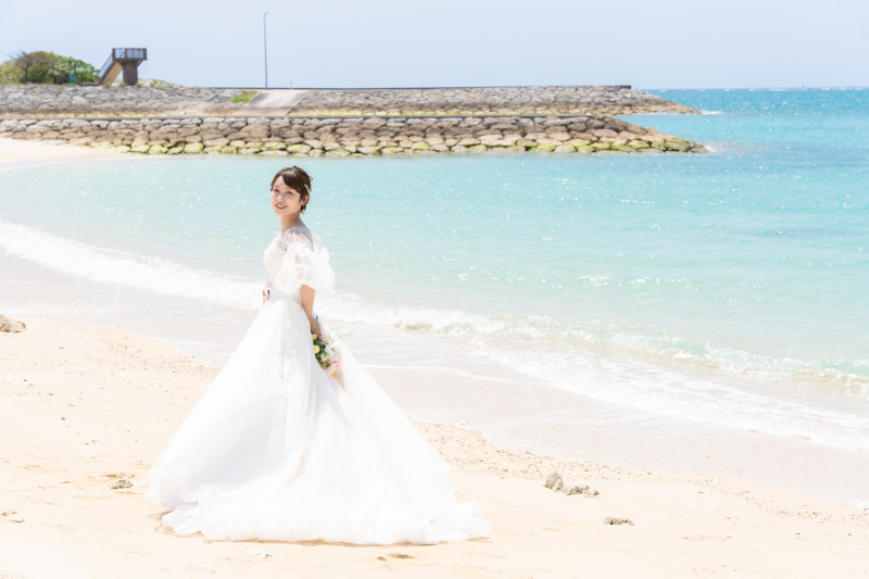 青い海と純白ドレスのコントラストが美しい一枚です