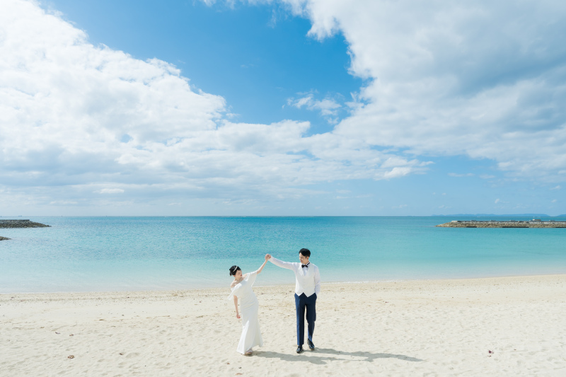 白いドレスで歩くやさしいビーチ