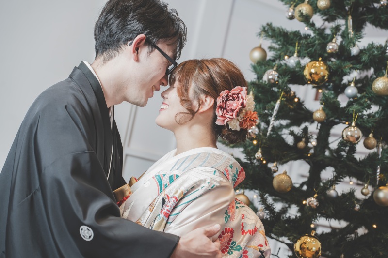 結びはシーズンならではのクリスマスツリー前で