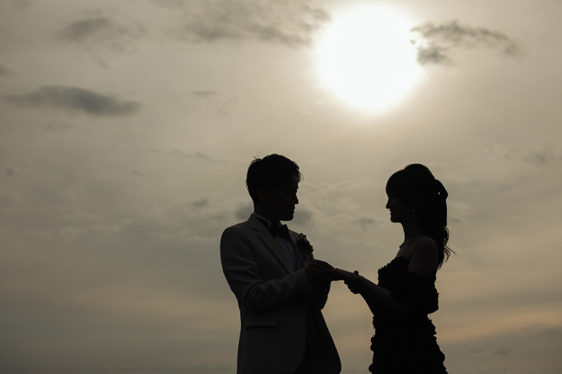 夕日を背に指輪を贈る神秘的なシルエット