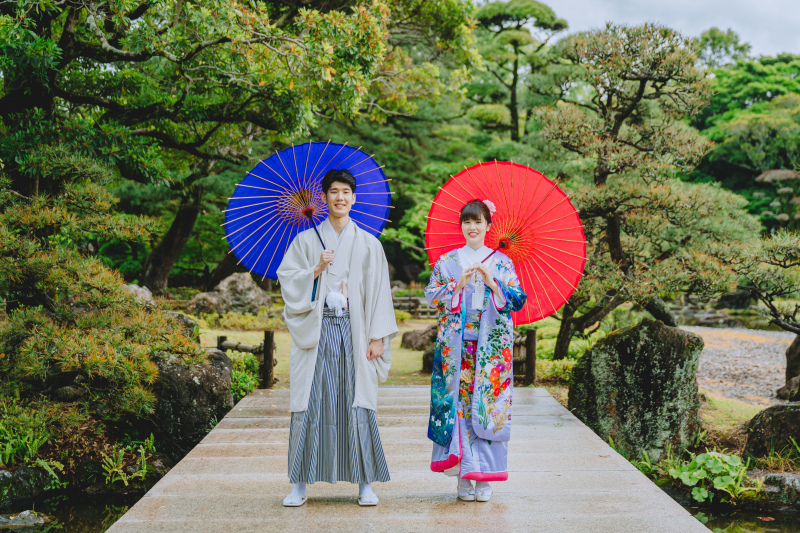 伝統美を感じる和装ショット。赤と青の番傘を添えて