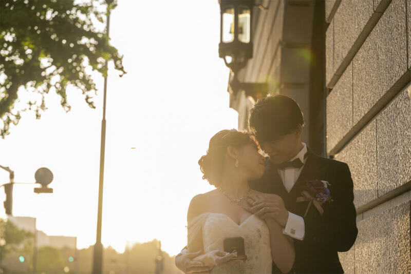 夕日を浴びる明治安田生命ビルとおふたり