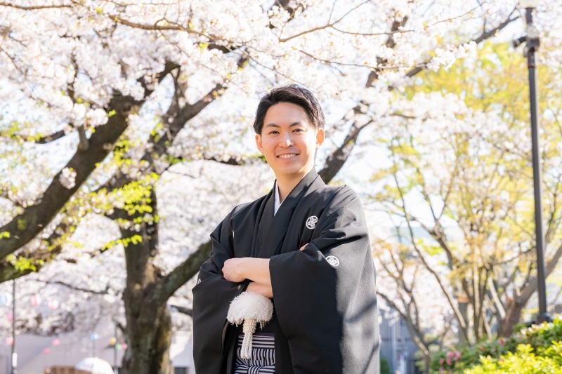 桜の季節に映える凛々しく、黒色で王道な紋付袴姿。