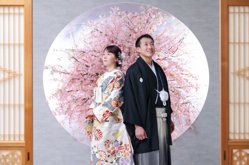 桜のモチーフを背にした背中合わせのカット