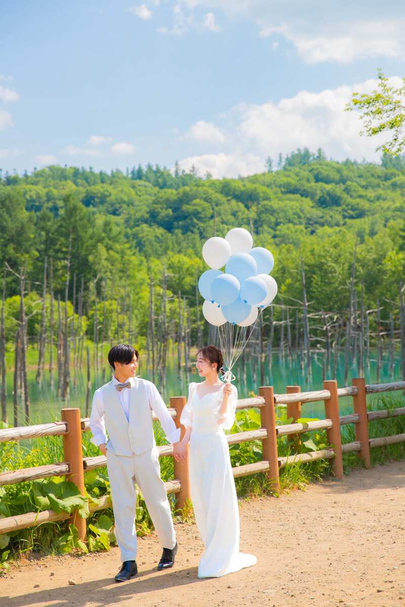 青い池を背景に風船と