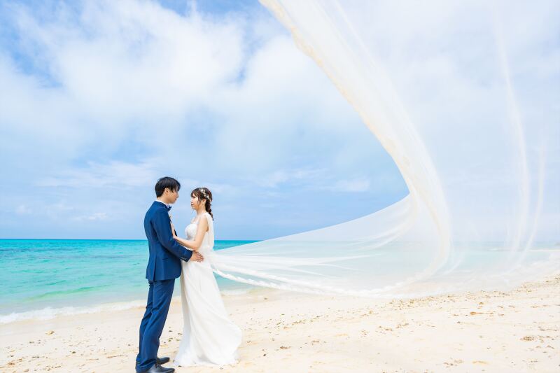 海風にふわりと舞うロングベールとおふたり