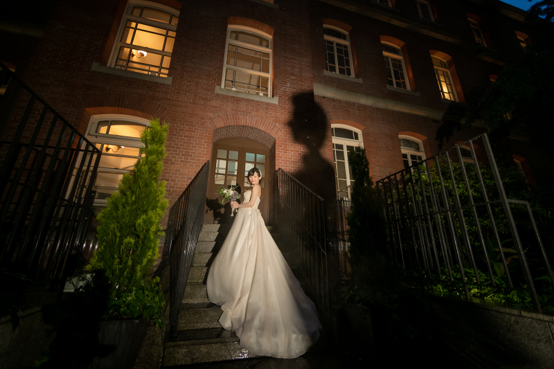 ライティングにより赤レンガに映し出されたご新郎