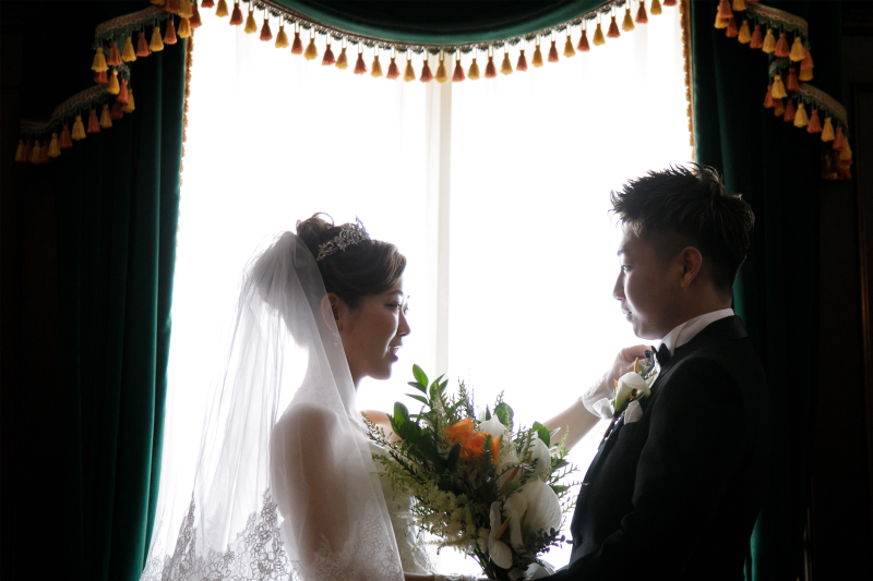 さりげなく新郎様のネクタイを整える新婦様、ステキです。