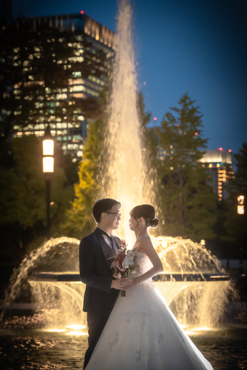 噴水の光を浴びながら向き合うふたりの表情