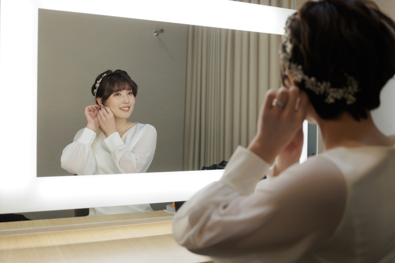 耳元に触れて整える動作