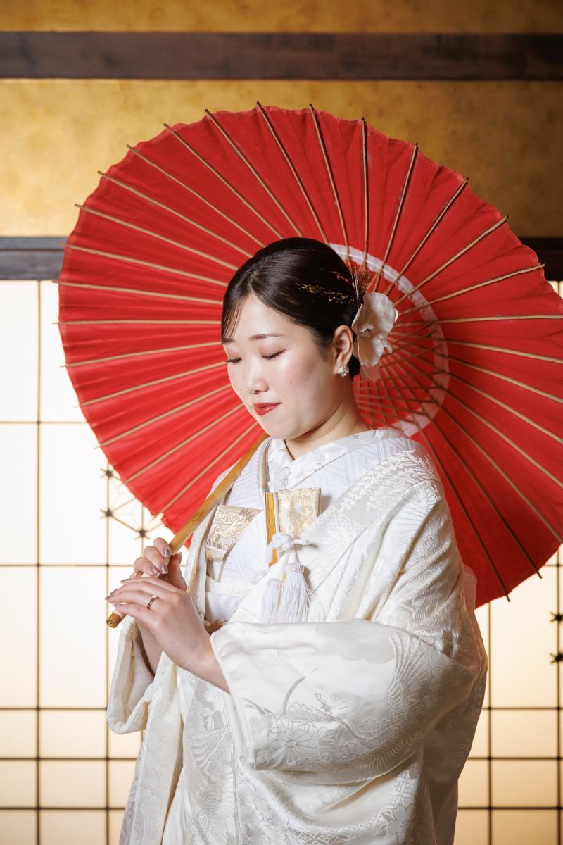 目を伏せて番傘を手にする白さ