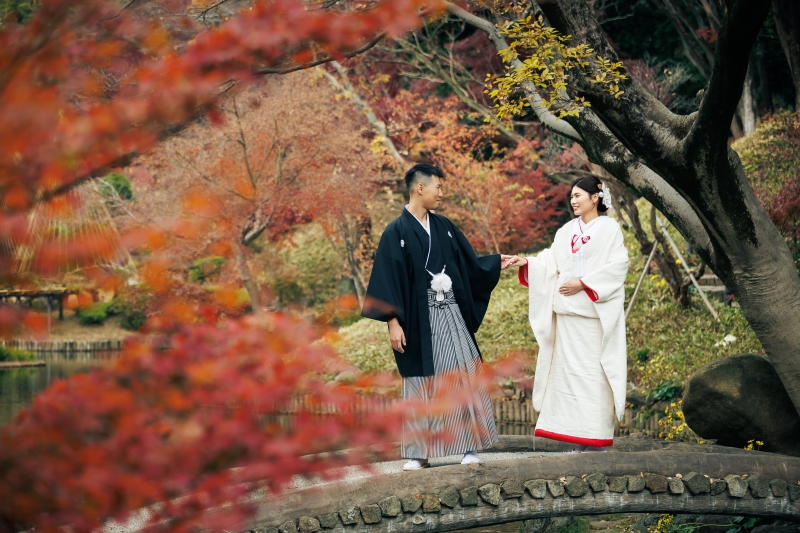 紅葉の池畔で向き合うふたりの穏やかな空気