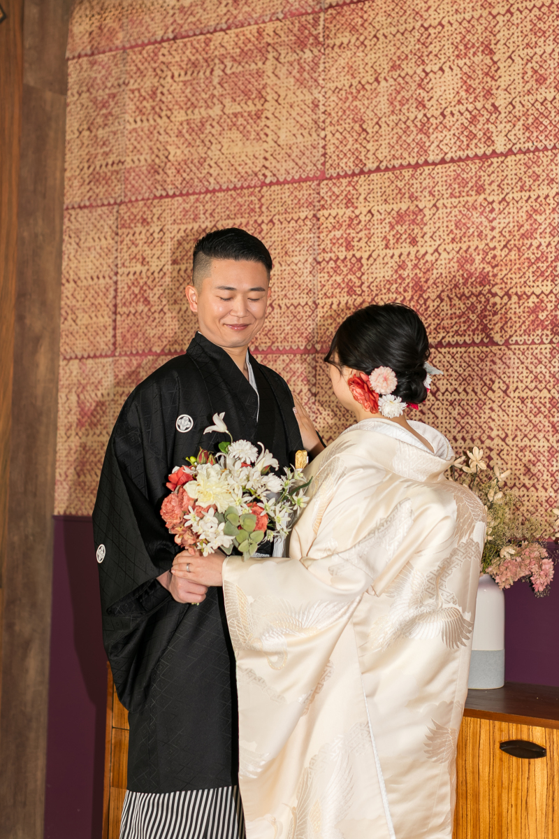 お花を見てるご新郎様を見つめるご新婦様