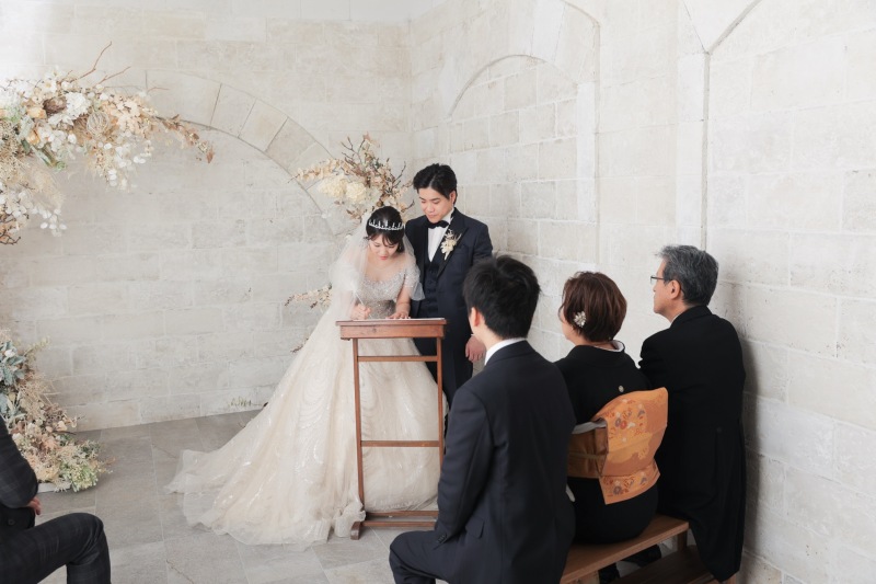 ご家族様に見守られながら新婦様もサイン