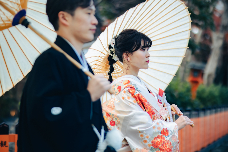 ふたりで傘を持って見据える姿を