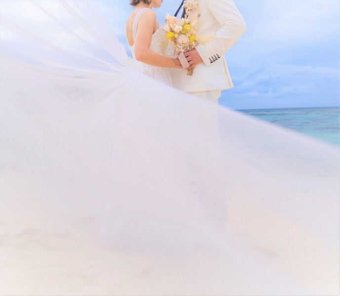 風に揺れるロングベールは、まるで物語の中にいるかのような幻想的な雰囲気を演出してくれます。宮古島の自然光と青い海、緑の景色が重なり合う中で、優雅に広がるベールが特別な一枚を彩ります。ぴったりの演出です