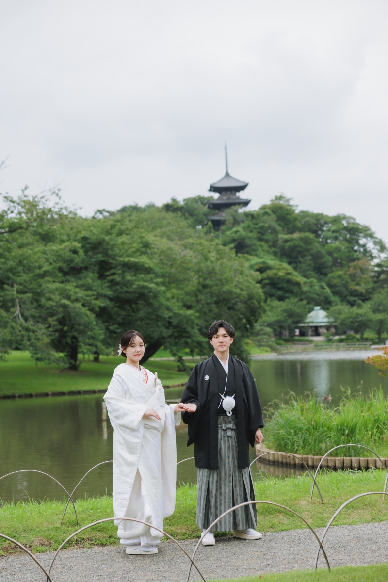 遠くにそびえる塔と、池のほとりで