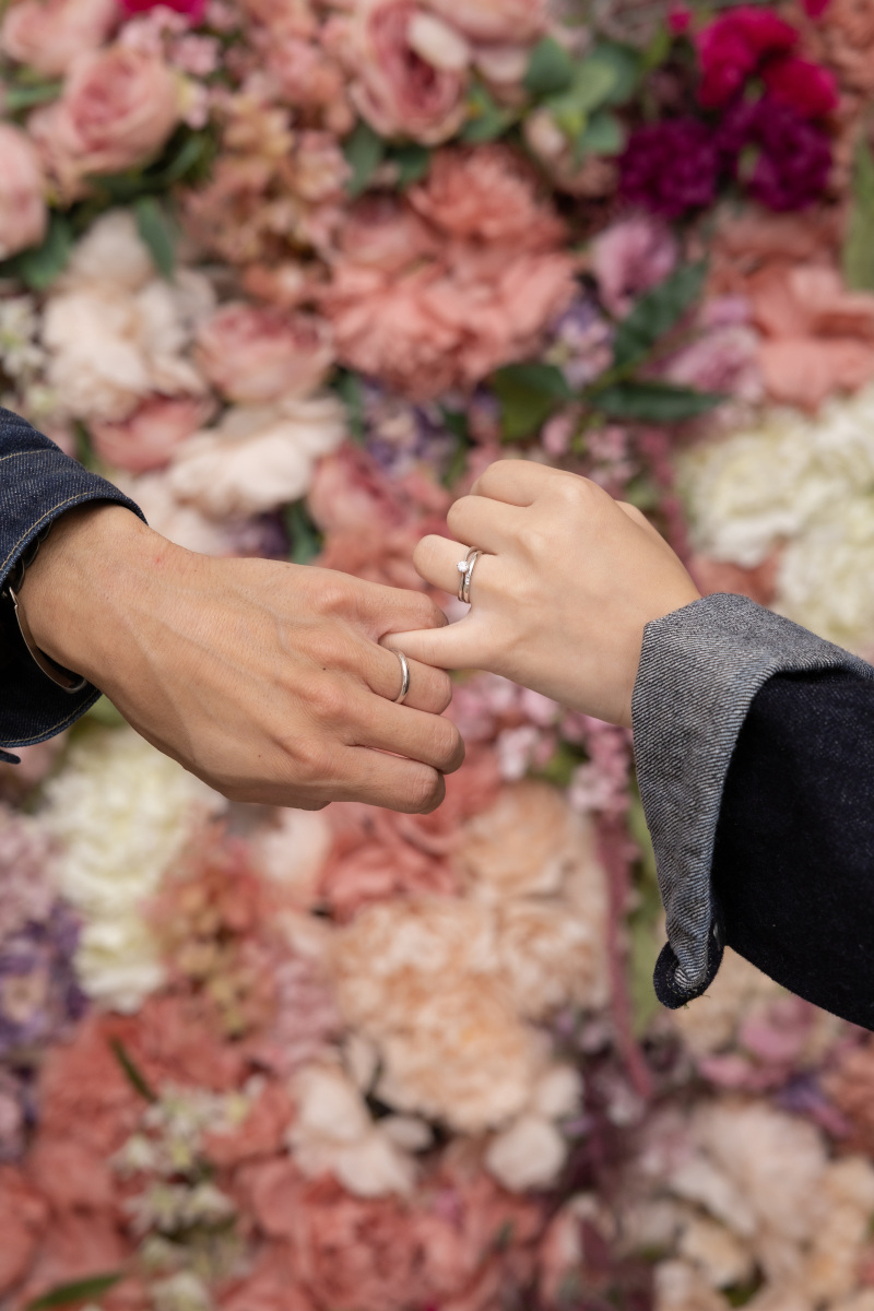 お花の壁を背景に