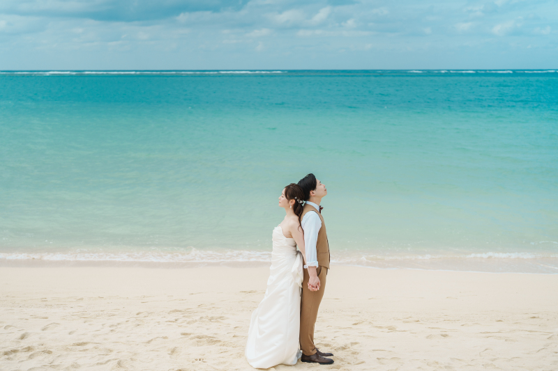 背中合わせで手を取り合うおふたり